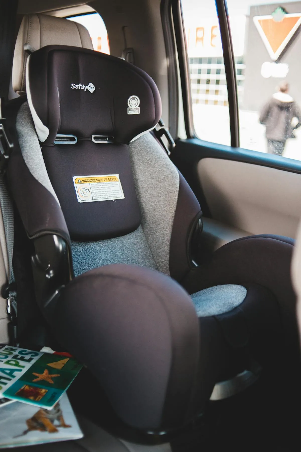Two children safely buckled in car seats