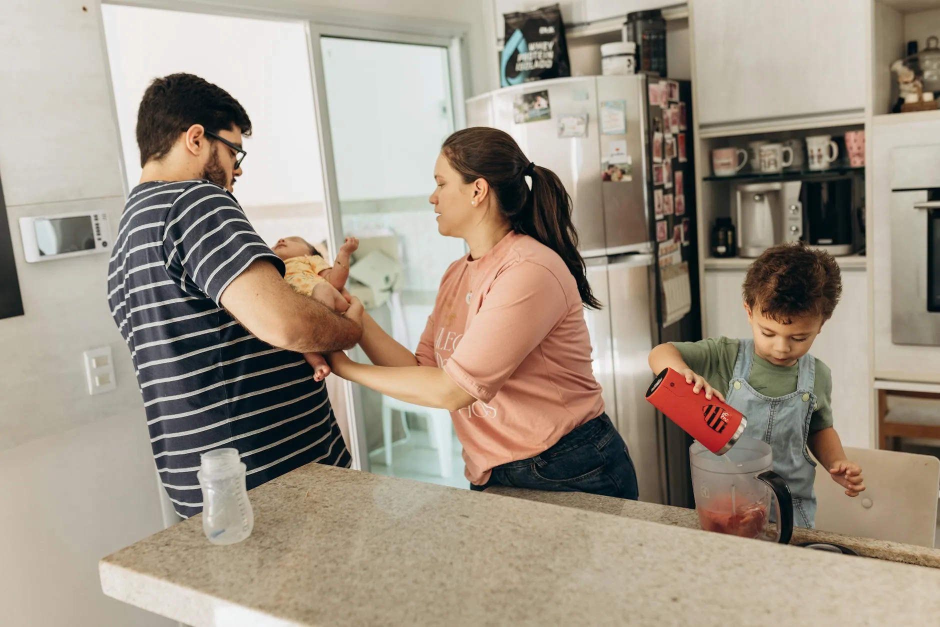 Parent preparing a baby bottle with milk in the kitchen