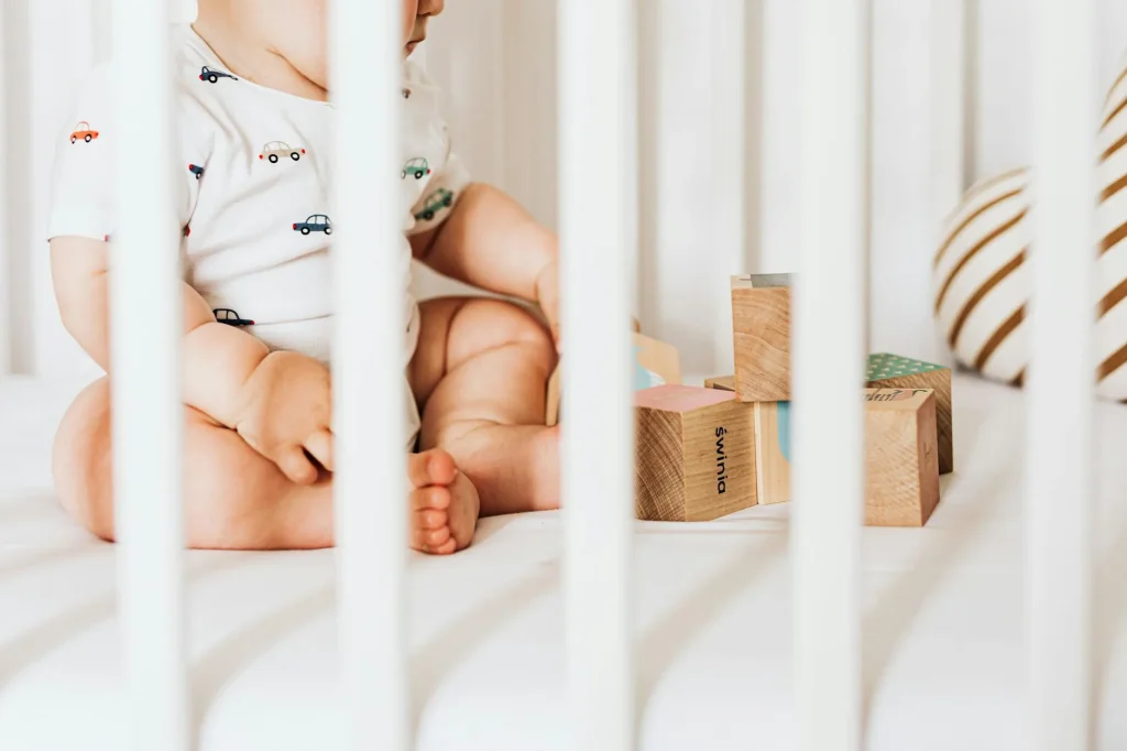 Baby monitor camera positioned near a cot in a nursery