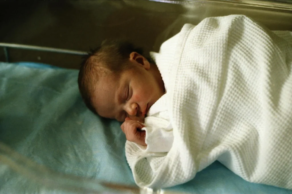 Baby sleeping peacefully in a cot