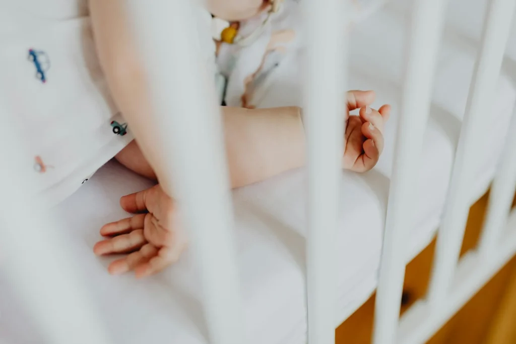 Baby sleeping peacefully in a nursery crib