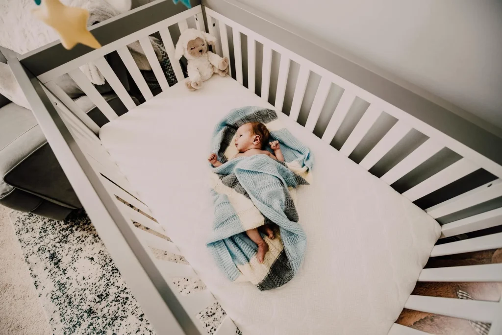 Baby sleeping peacefully in a nursery crib being monitored