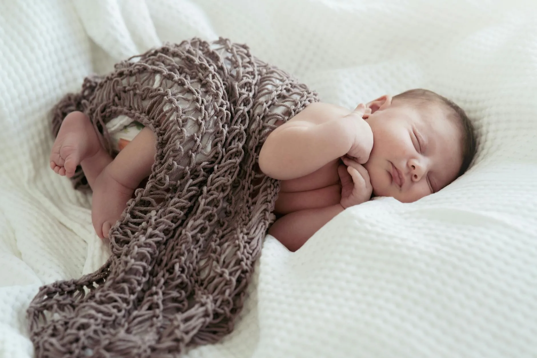 Baby sleeping peacefully in a comfortable pushchair pram