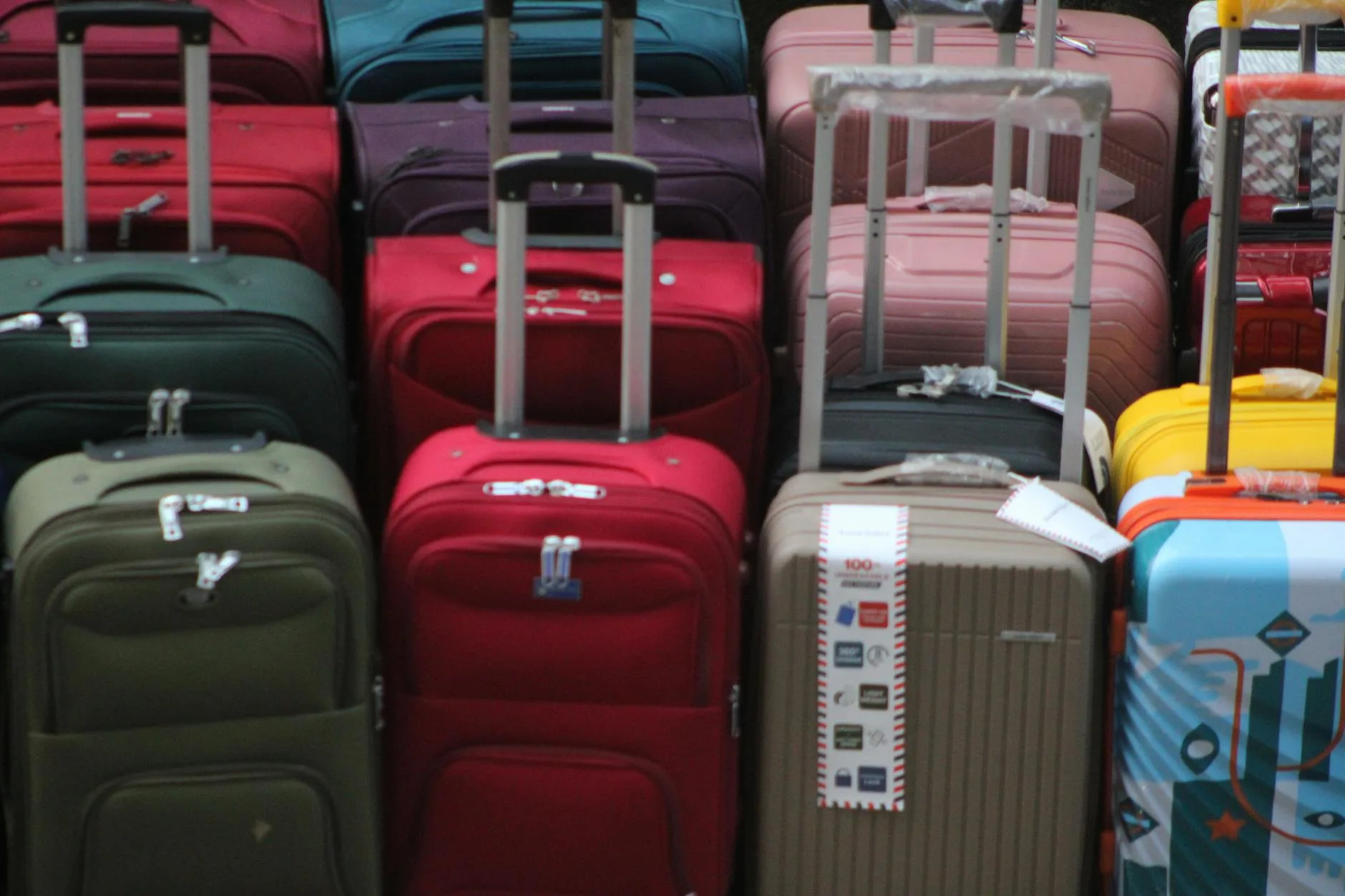 Padded travel bag for a child car seat beside luggage at an airport