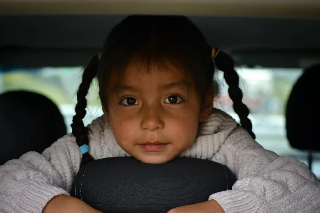 Toddler buckled safely into a car seat in a vehicle