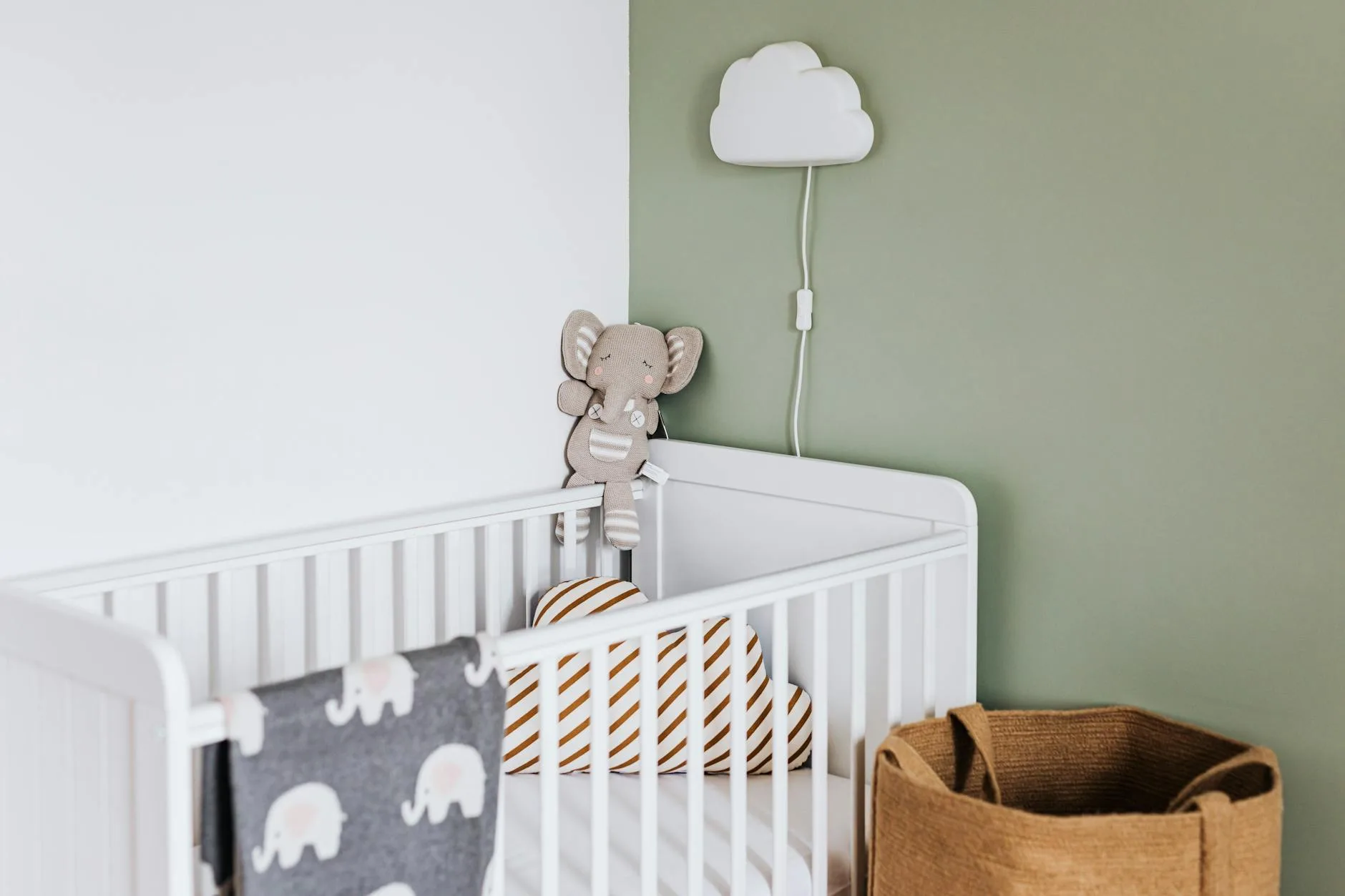Peaceful nursery with night light and cot ready for sleep
