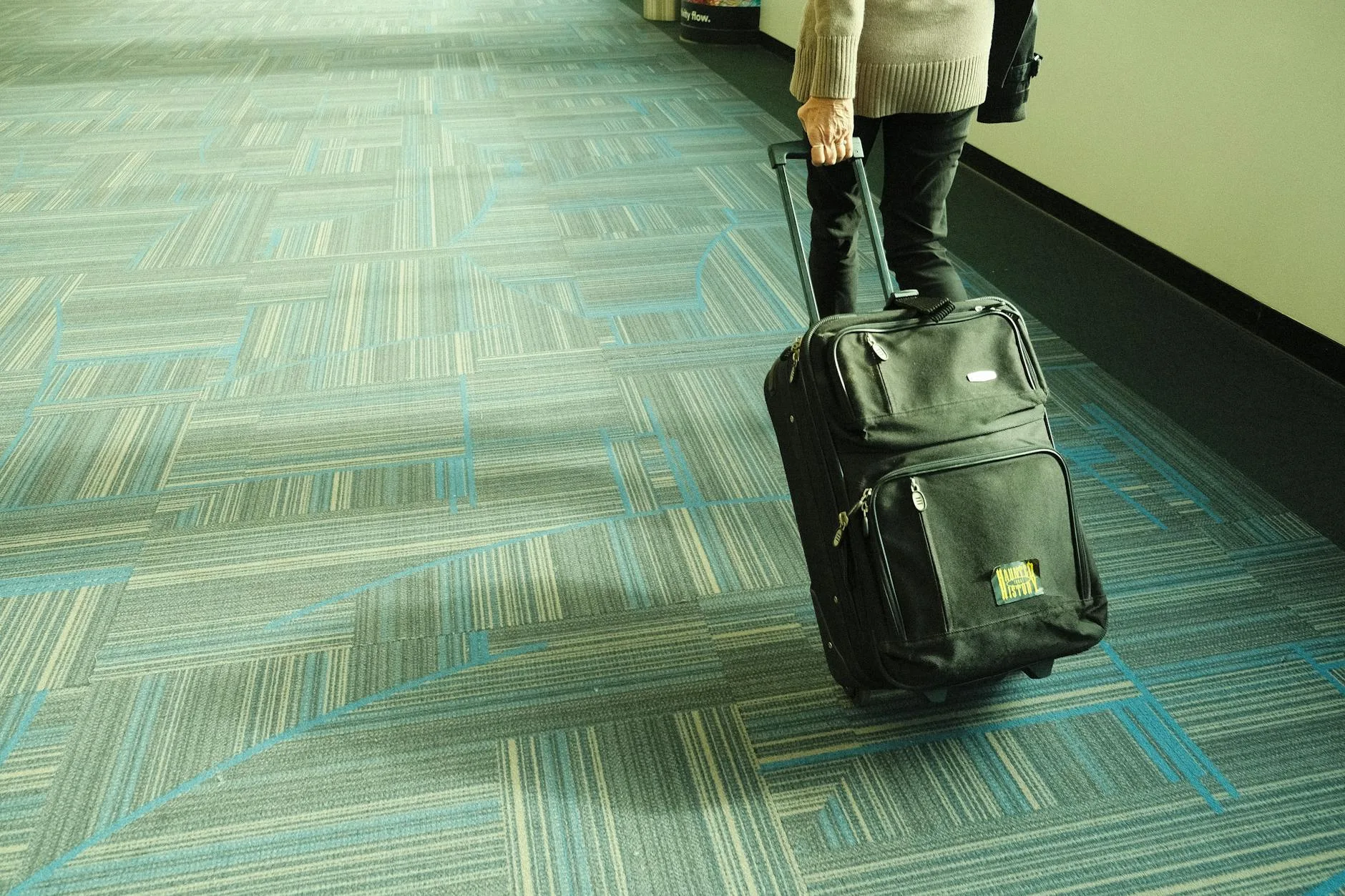 Family at an airport with luggage ready to travel with young child