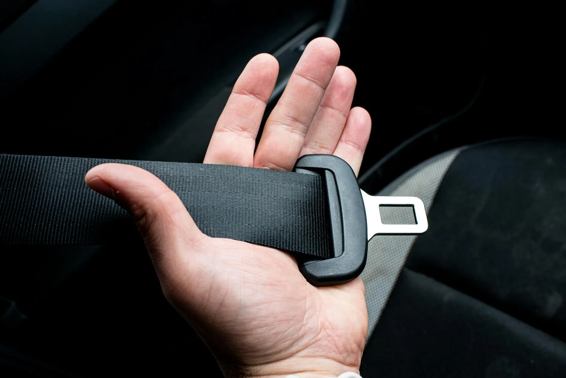 Parent installing a baby car seat into a vehicle using ISOFIX