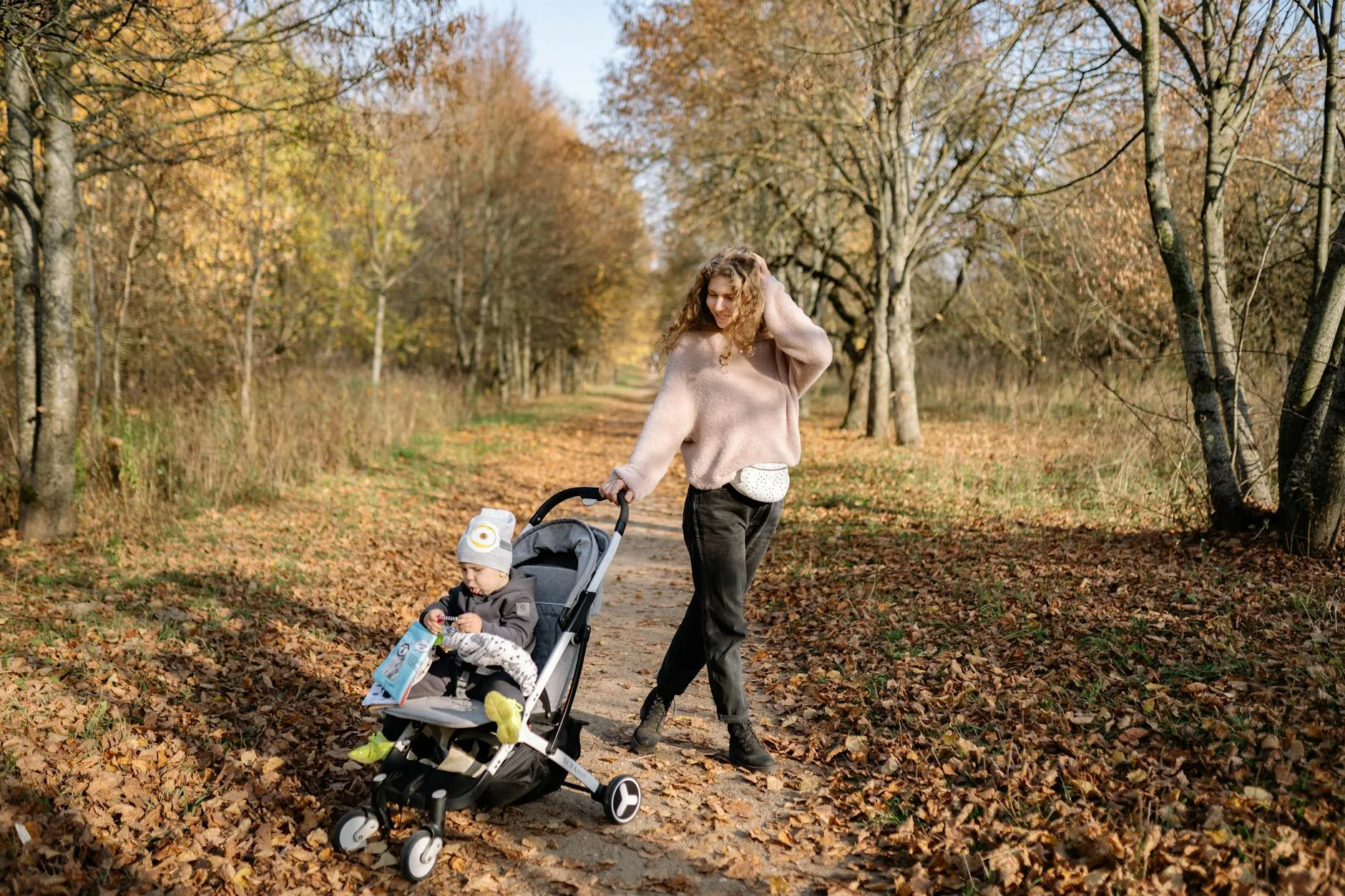 Pushchair on a gravel park path during an autumn walk