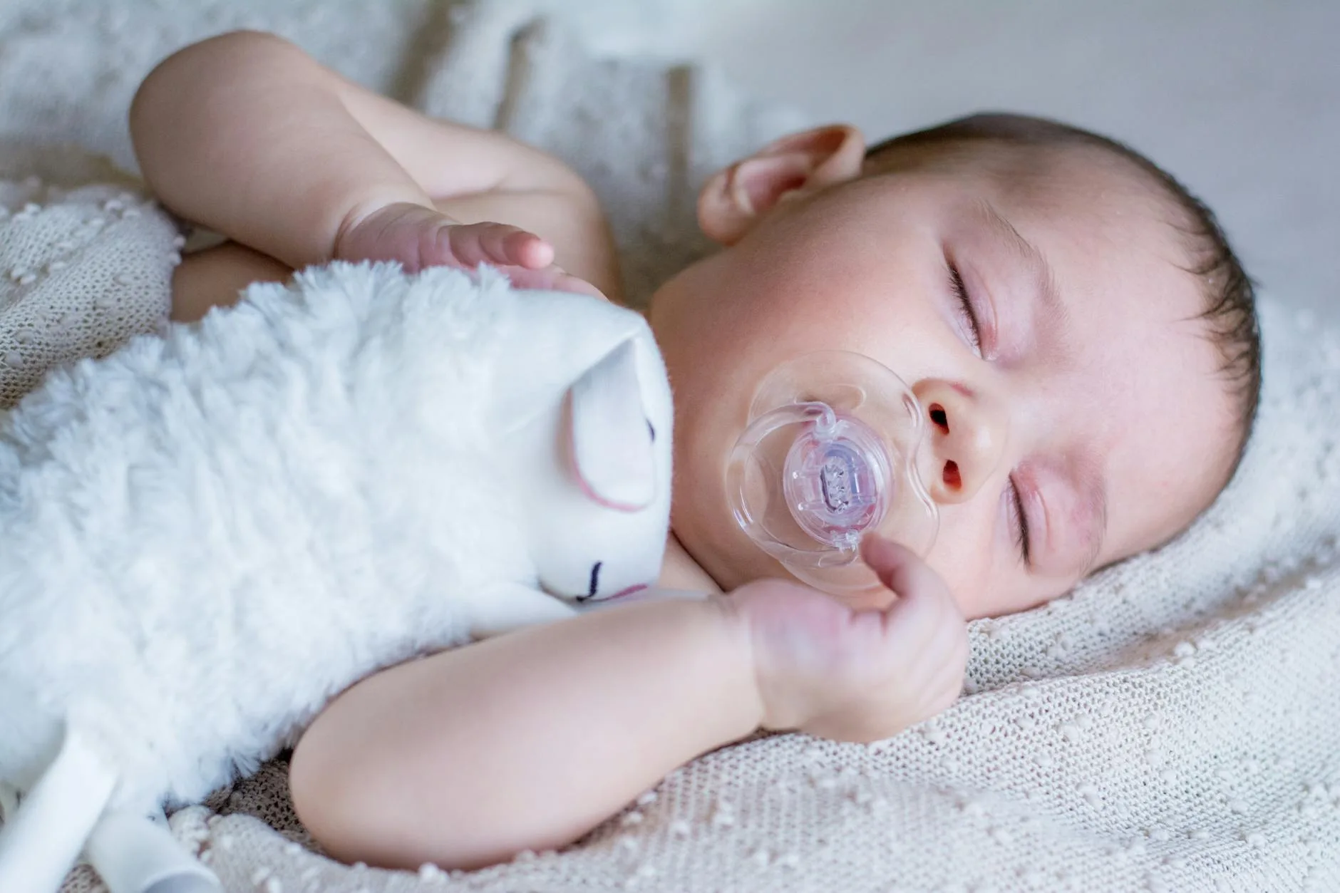 Baby sleeping peacefully in a cot in a nursery