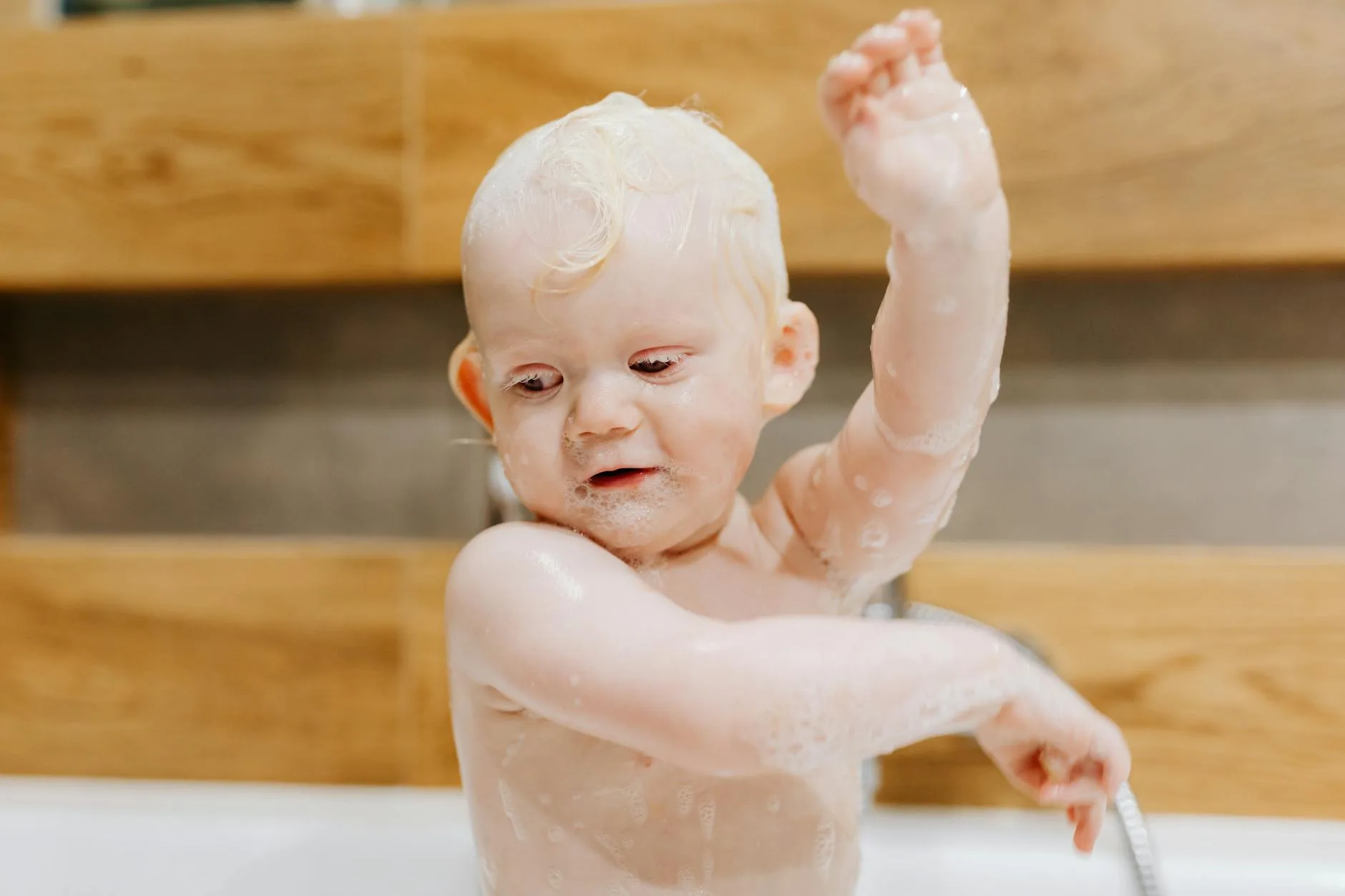 Toddler enjoying bath time as part of bedtime routine