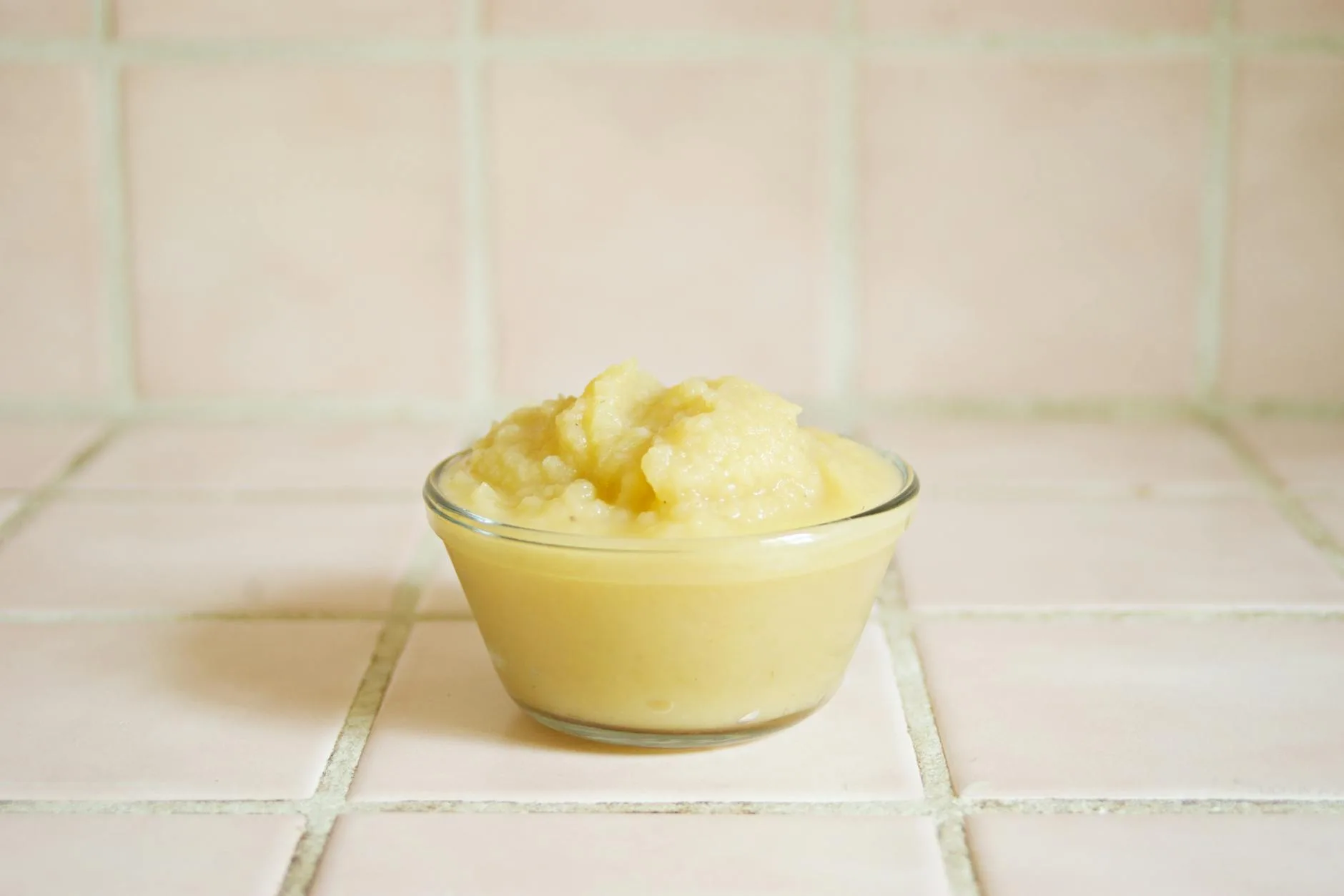 Colourful vegetable puree in a bowl with a baby spoon