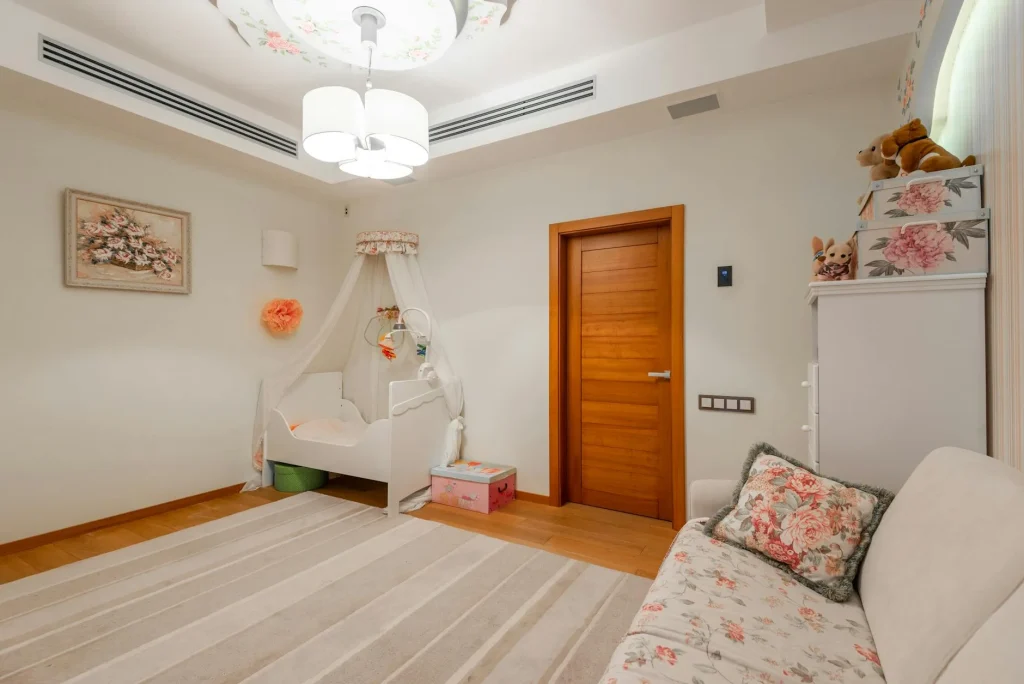 Baby cot in a nursery room with monitor camera