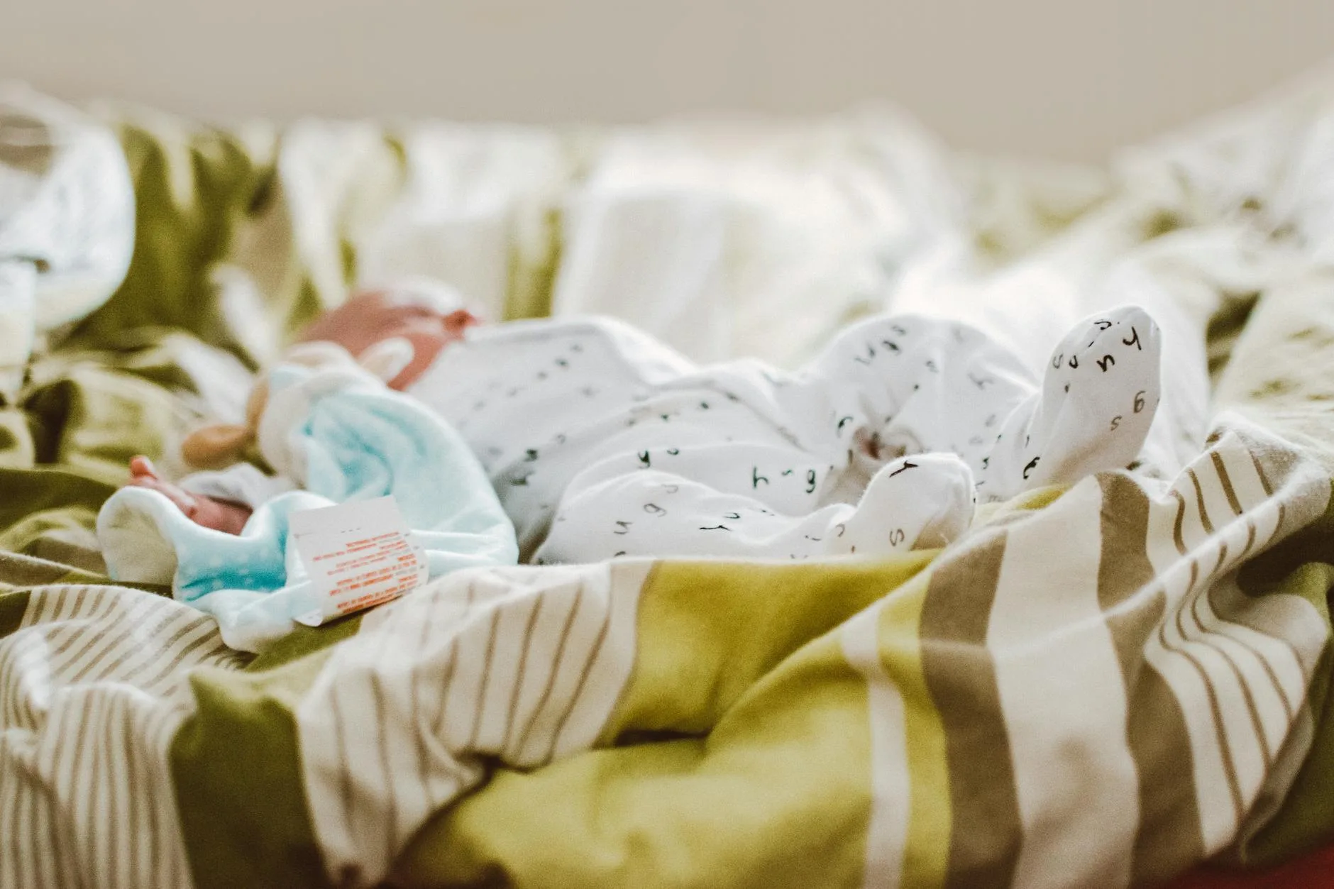 Newborn baby sleeping peacefully in a cot