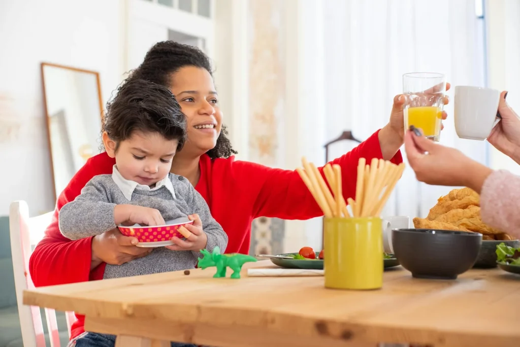 Toddler drinking water from a colourful cup