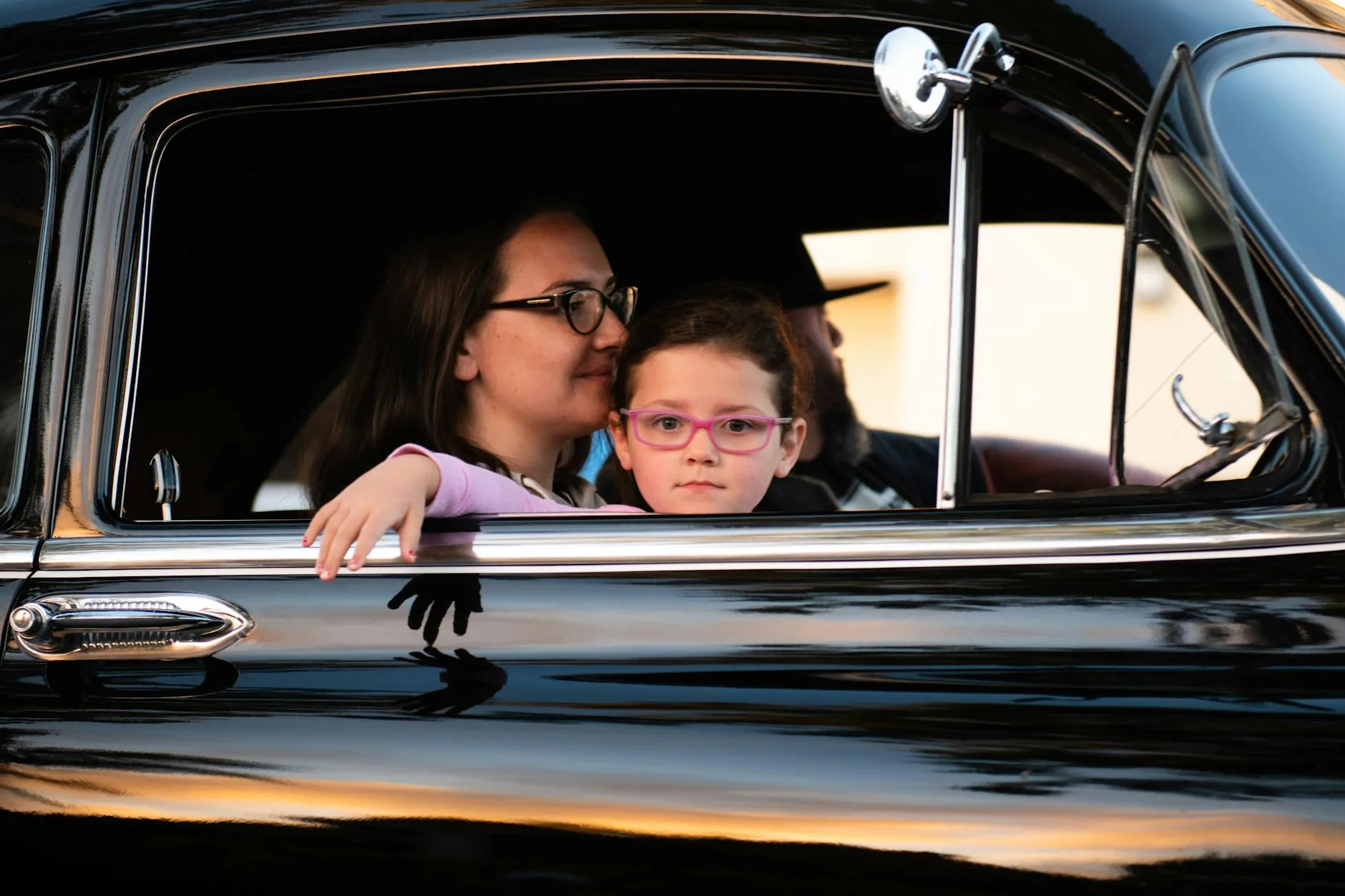 Family with children in the back seat of a car