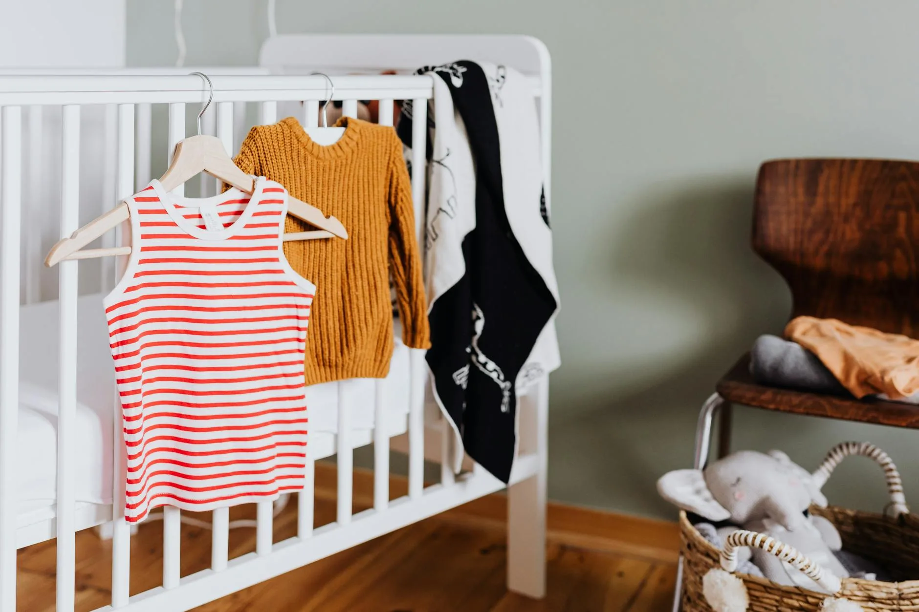 Clean nursery room with baby cot and soft lighting