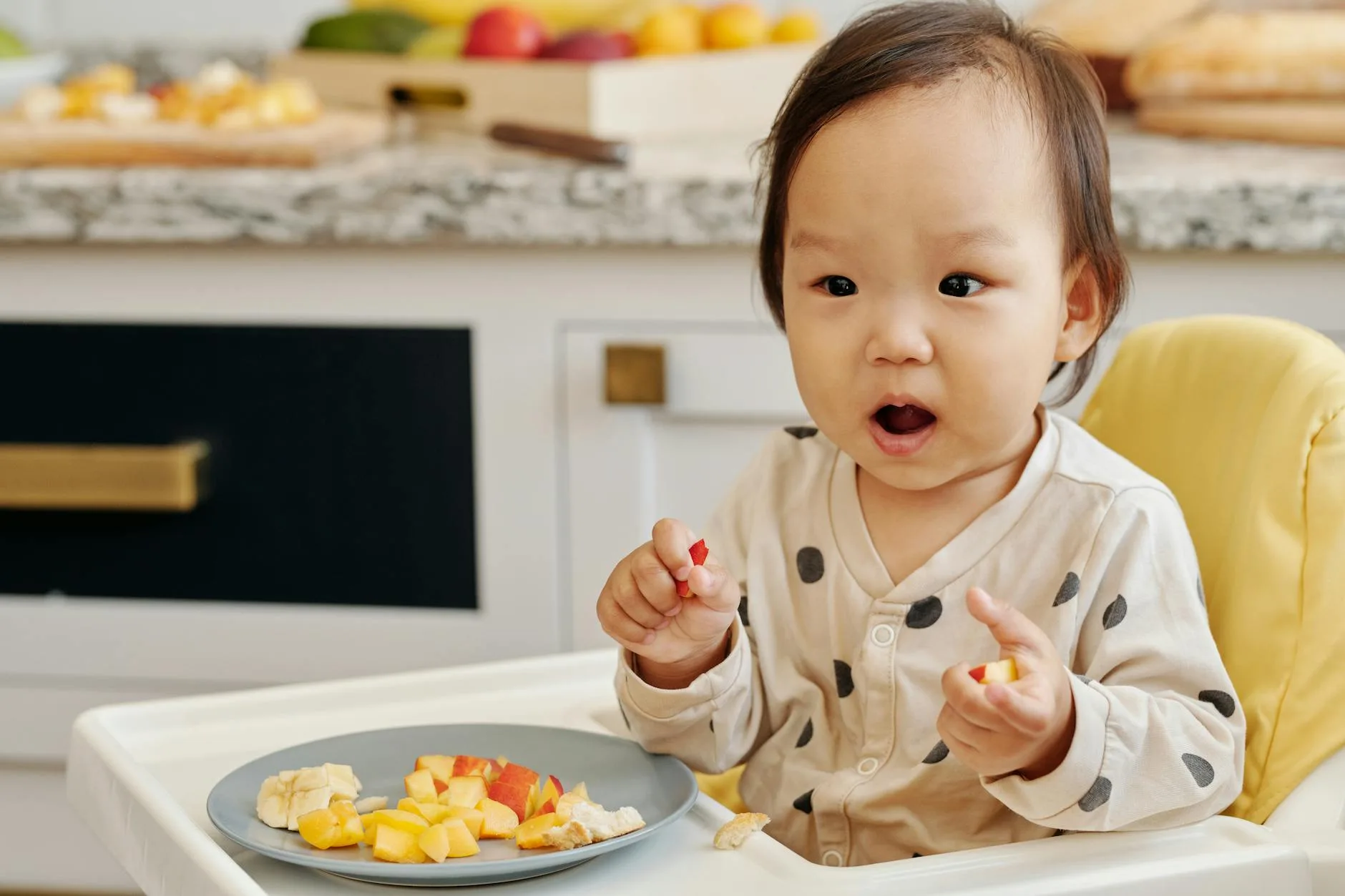 Toddler in a highchair during mealtime with food
