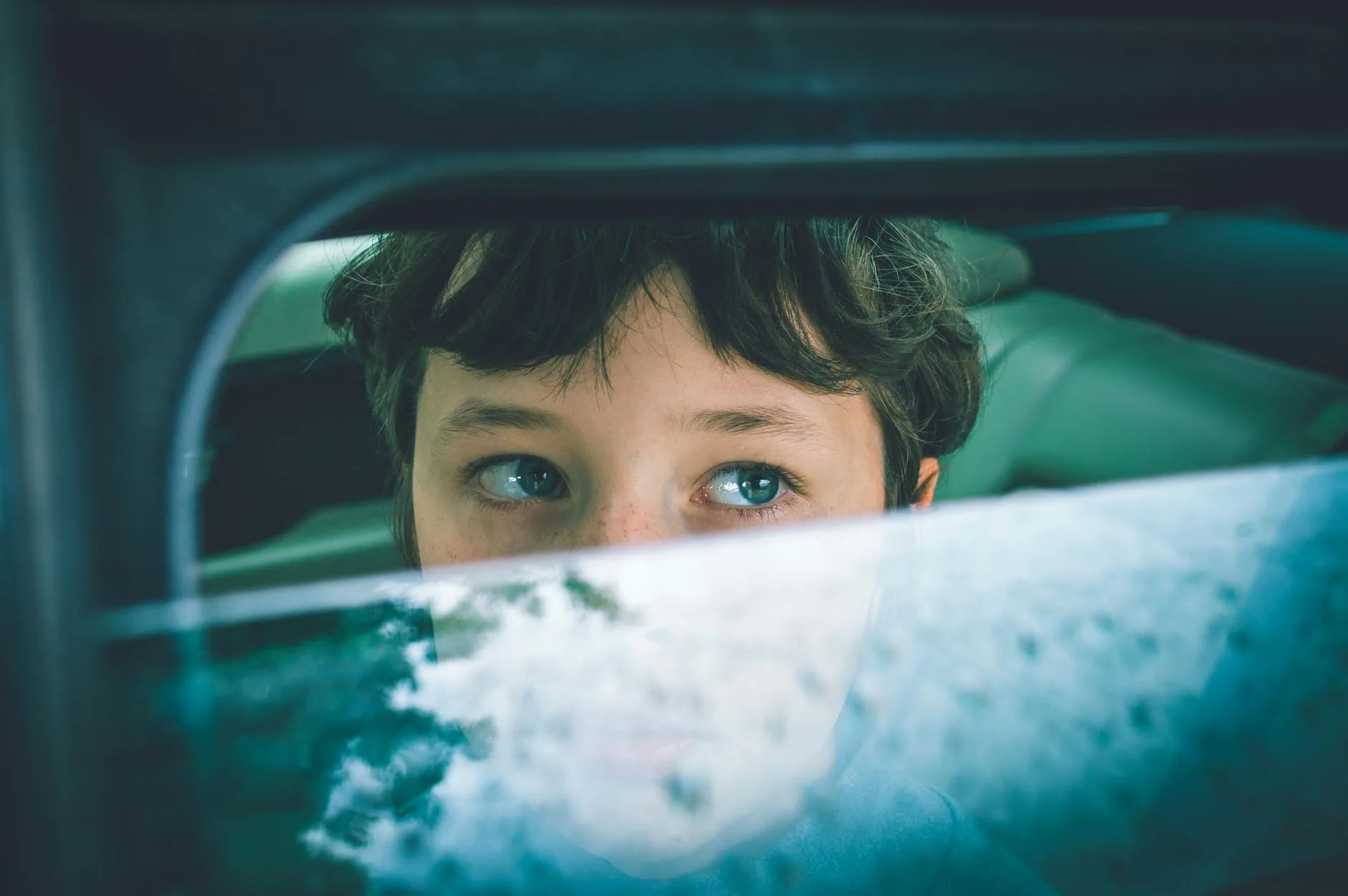 Toddler sitting in the rear seat of a car
