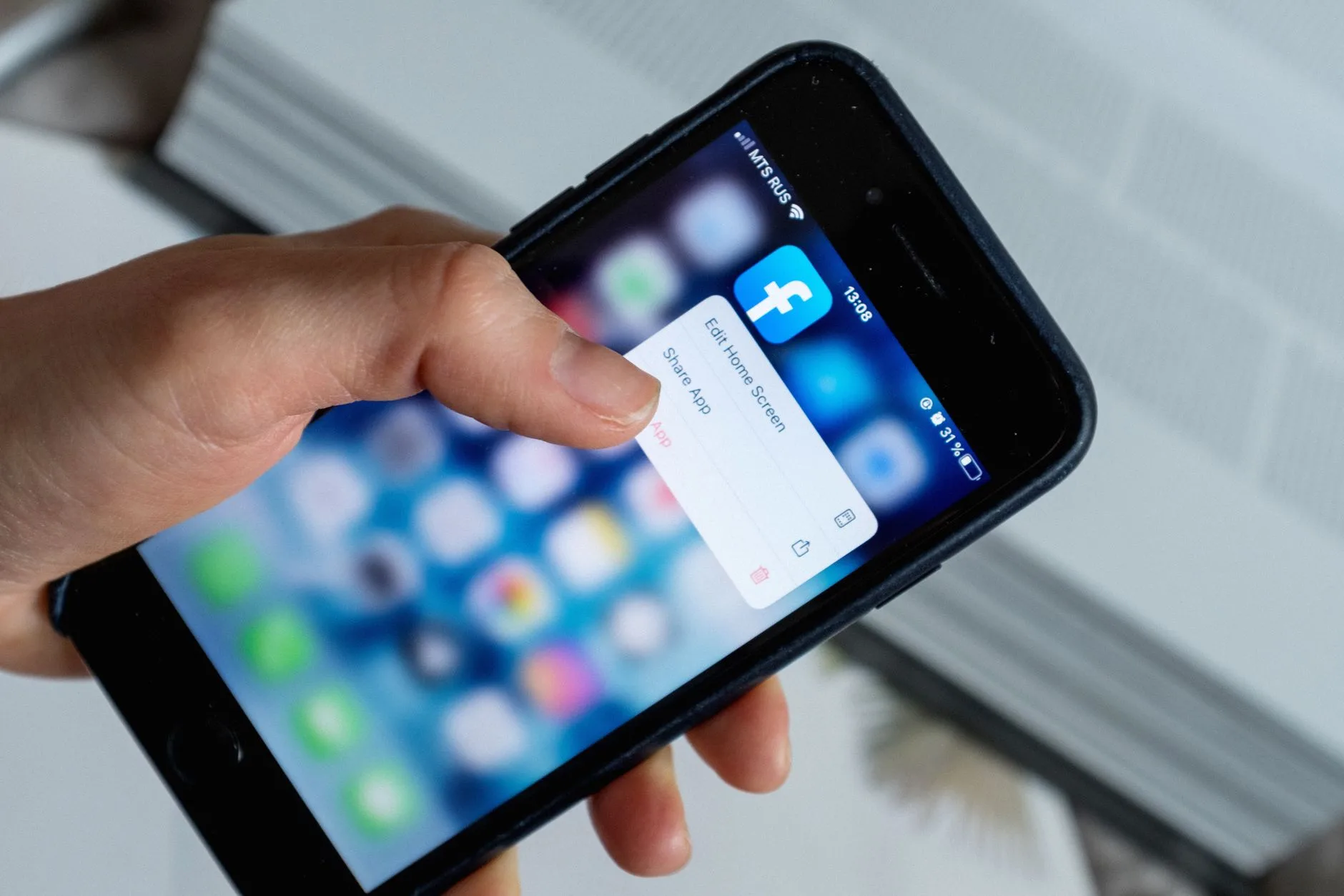 UK parent adjusting permissions for baby monitor app on mobile phone