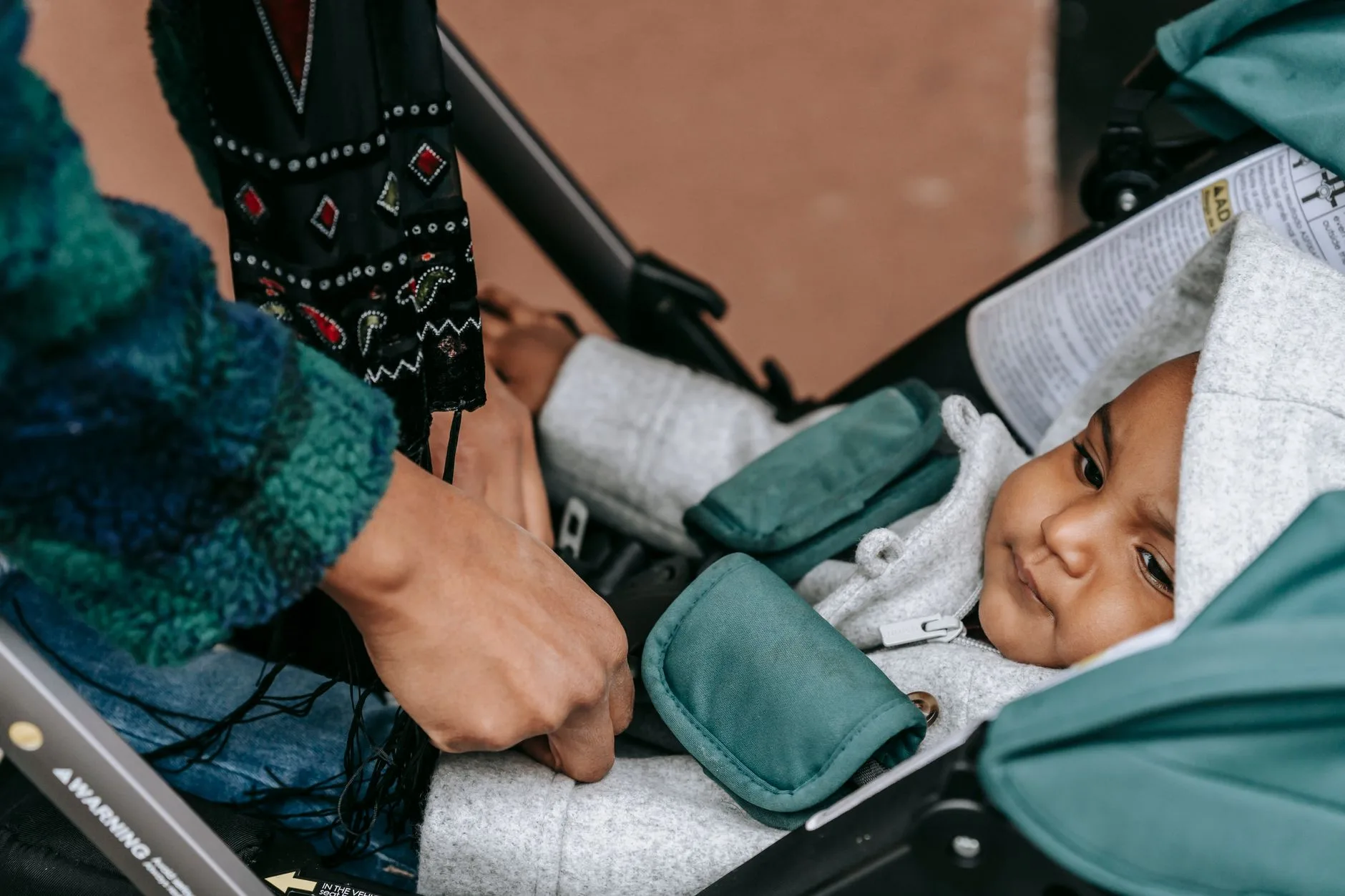 Close-up of a safe pushchair harness fit