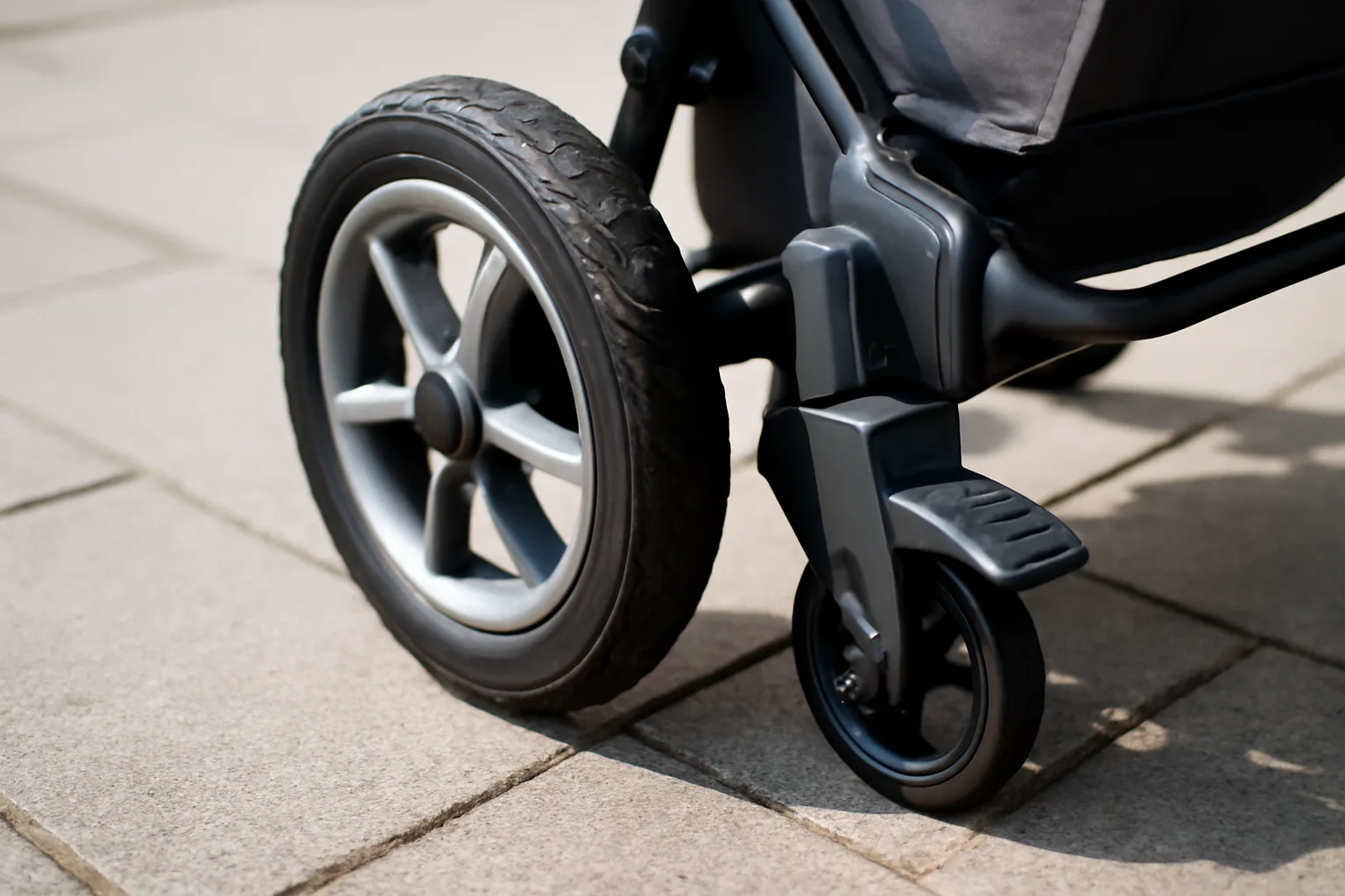 Pushchair wheel and foot brake detail