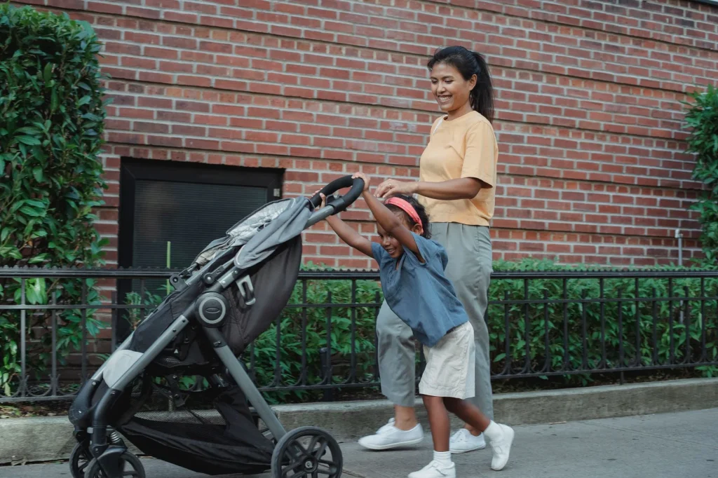 Lightweight stroller and full size pushchair compared on a pavement