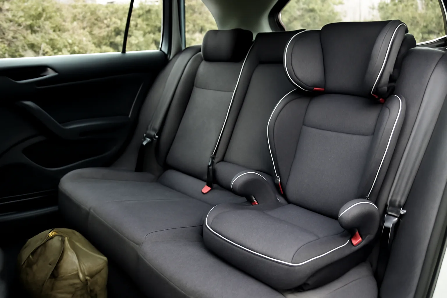 High-back booster seat fitted in a car before a UK trip